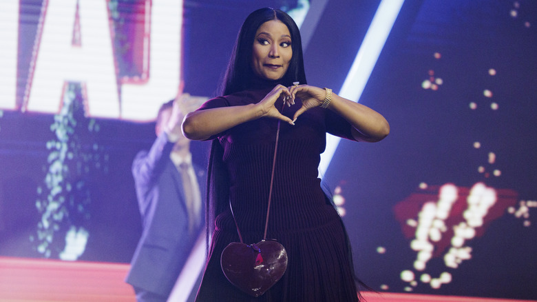 Nicki Minaj giving a heart symbol with her hands