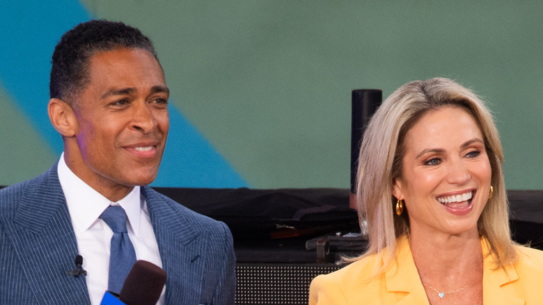 T.J. Holmes and Amy Robach speaking onstage