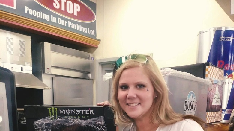 An Amy Schumer look-alike smiles with her prize at Celina Truck Stop