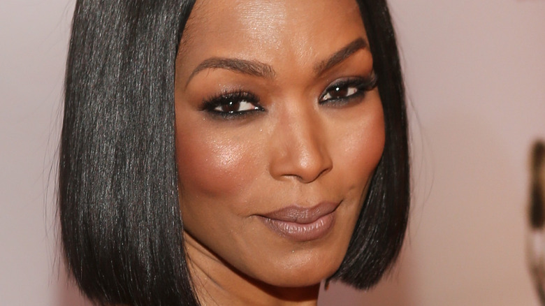 Angela Bassett with her hand on her hip