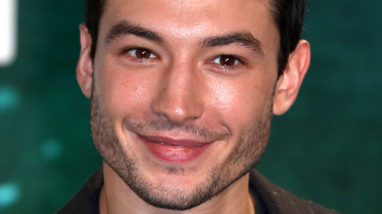 Ezra Miller slight smile on red carpet for Justice League