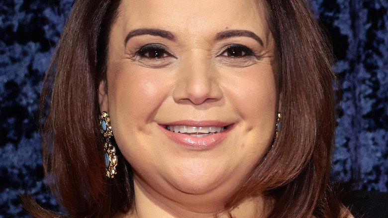 Ana Navarro slight smile, gold dangling earrings