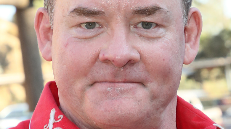 David Koechner tightly smiling