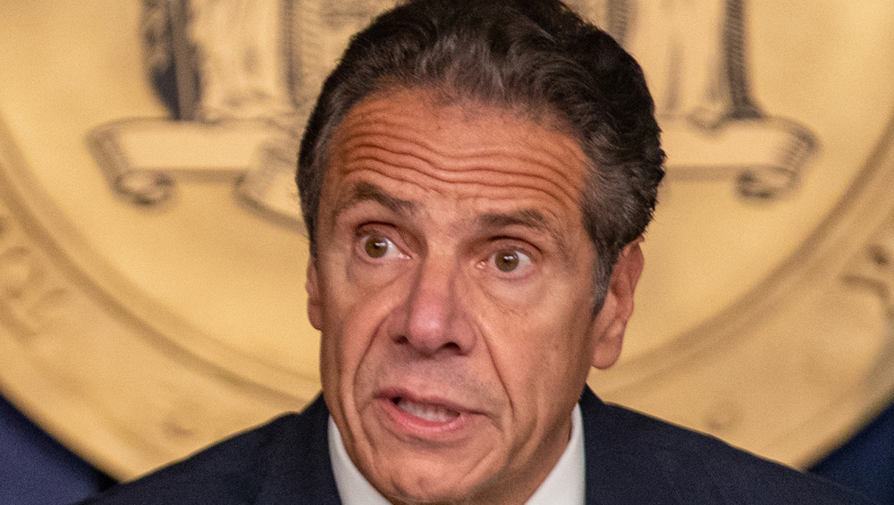 Andrew Cuomo looks animated while speaking to reporters at a call