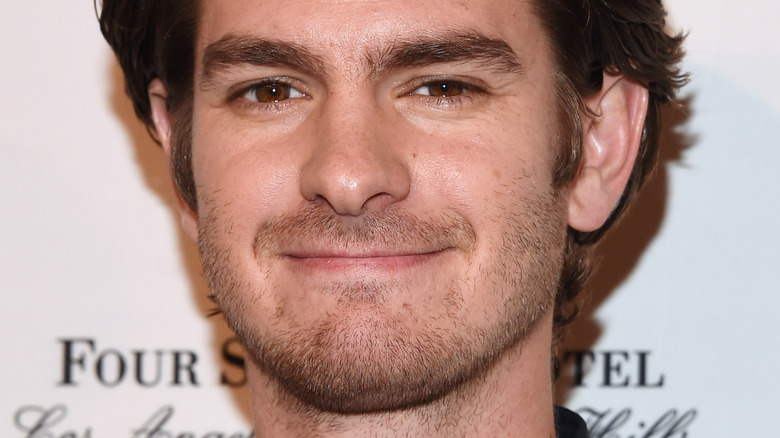 Andrew Garfield smirks