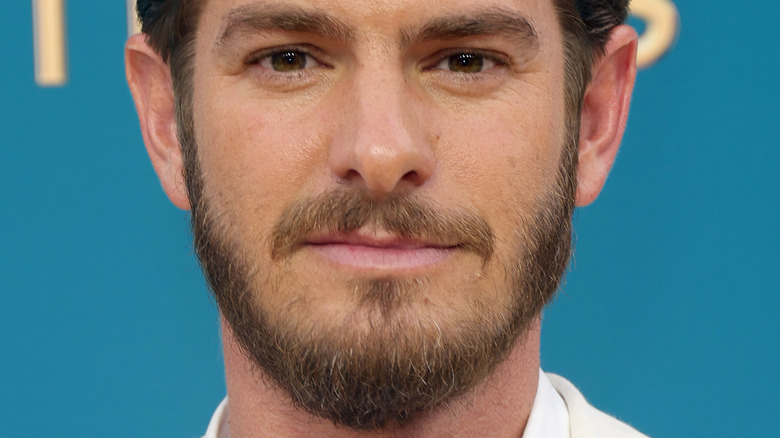 Andrew Garfield with beard not smiling