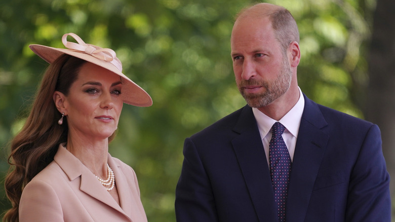 Kate Middleton and Prince William standing outside