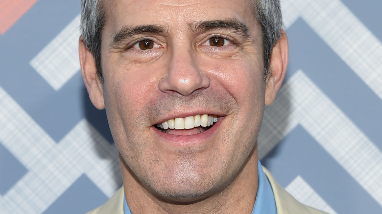 Andy Cohen smiling on the red carpet