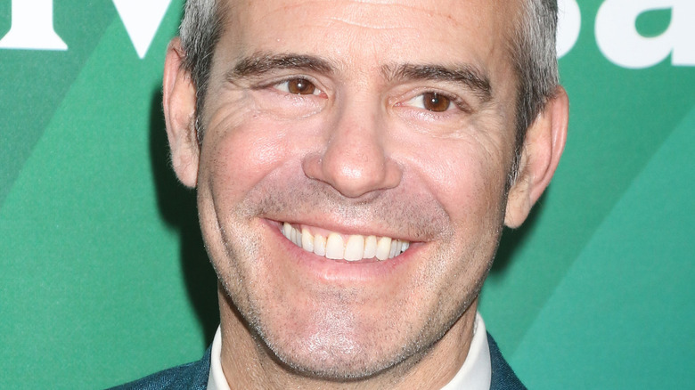 Andy Cohen smiling on the red carpet