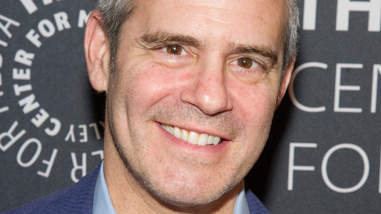 Andy Cohen smiling on the red carpet