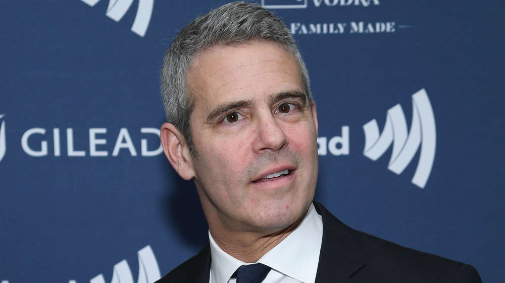 Andy Cohen smirking