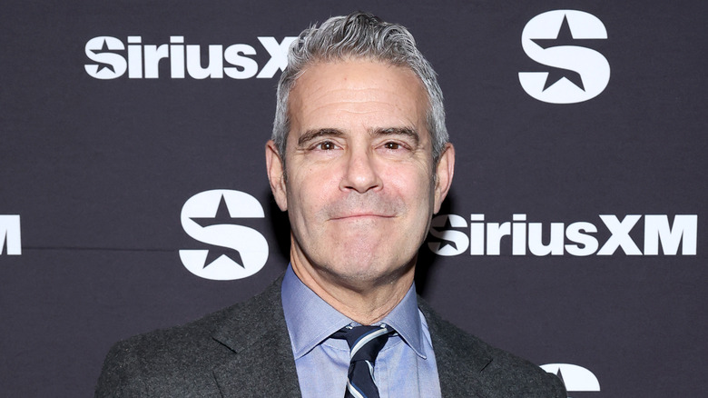 Andy Cohen smirking