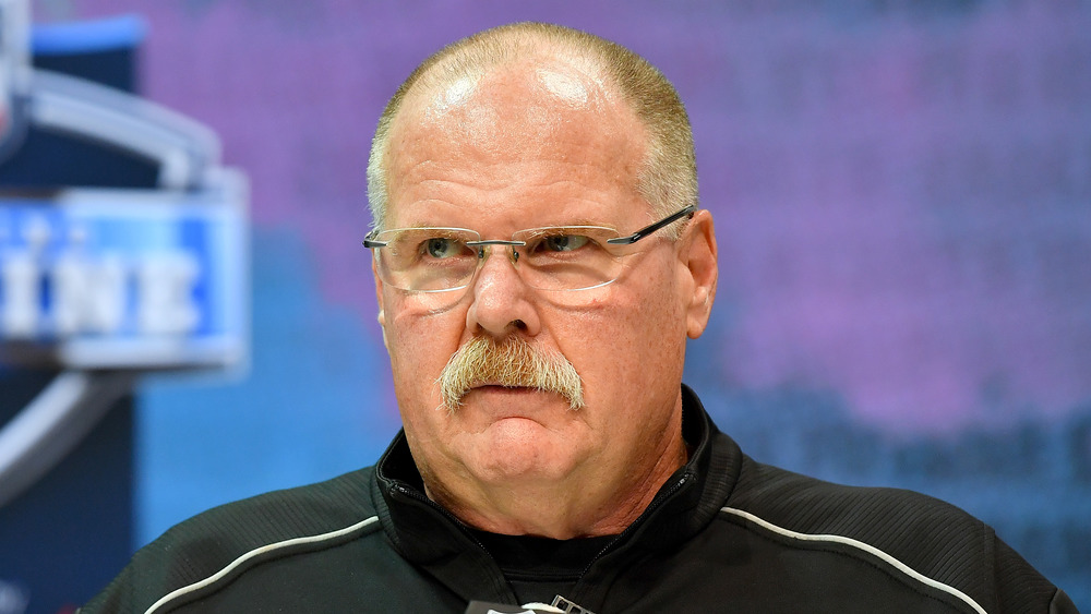 Andy Reid wearing glasses at a press conference