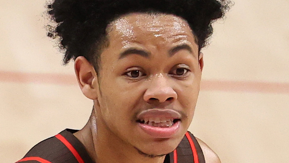 Anfernee Simons reacts after making a shot on the court