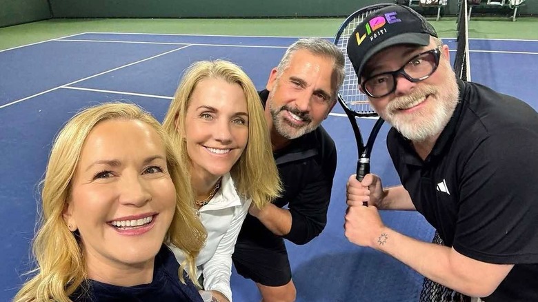 Angela Kinsey, Rainn Wilson, Steve Carell, and Nancy Carell posing on a tennis court.