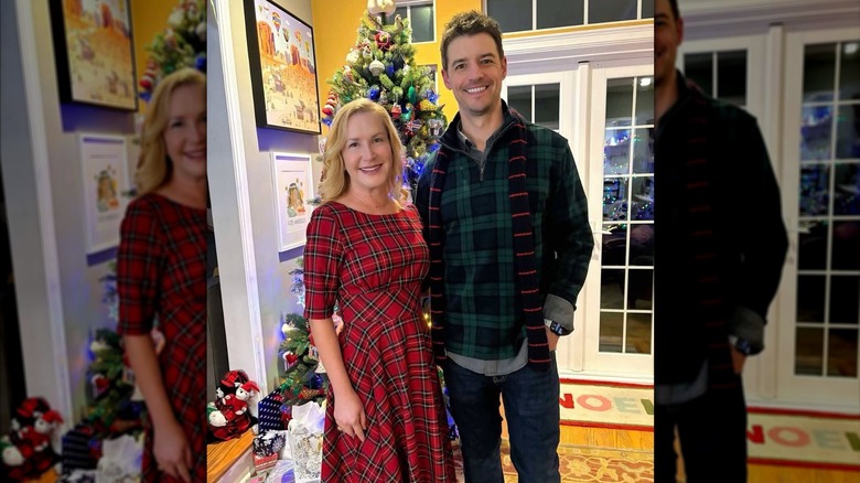 Angela Kinsey and husband Joshua Snyder posing together for the holidays.
