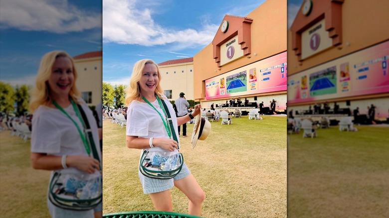 Angela Kinsey holding a straw hat at BNP Paribas Open in California.