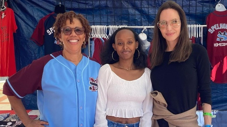 Angelina Jolie with Zahara Jolie-Pitt and a fan