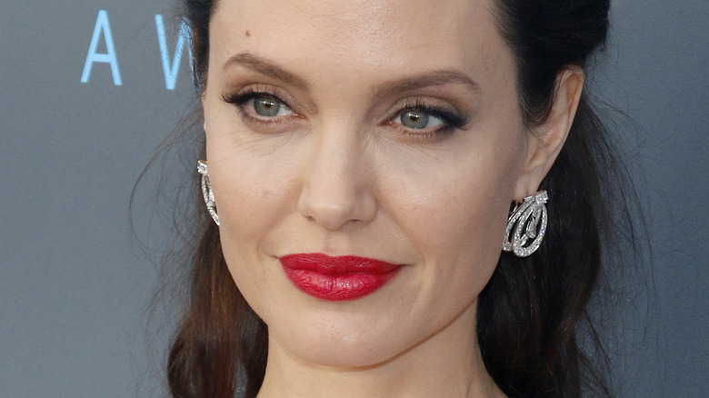 Angelina Jolie red lip large diamond earrings