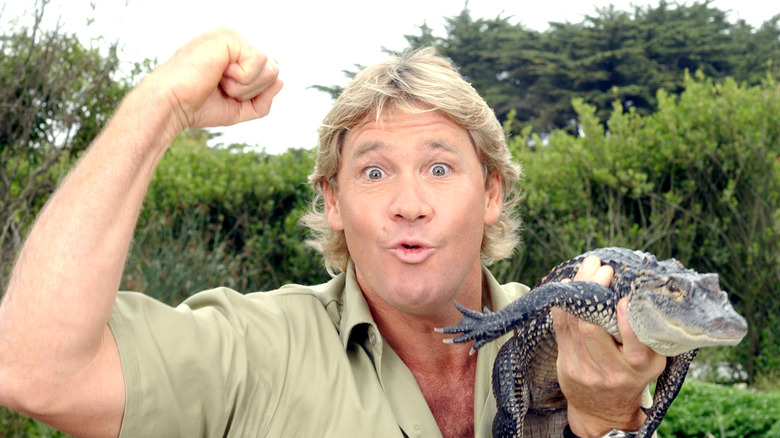 Steve Irwin holding a baby crocodile