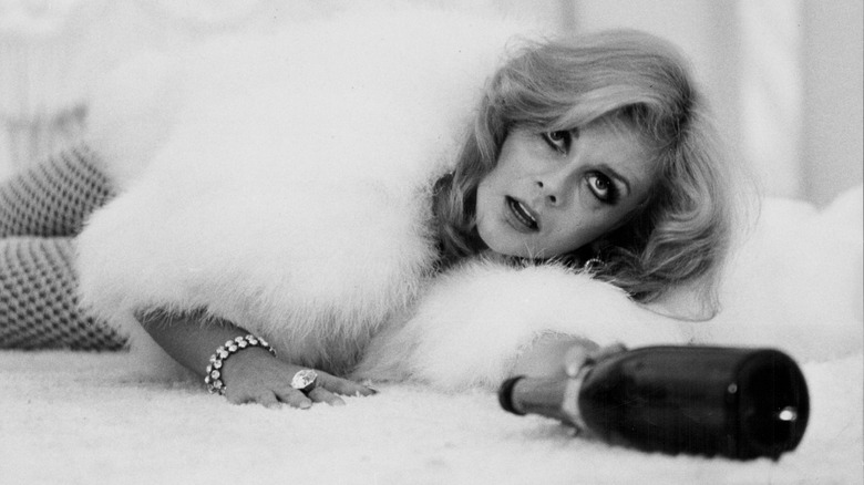 Ann-Margret with a champagne bottlein a scene from Tommy