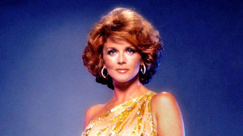 Ann-Margret posing in front of a blue background