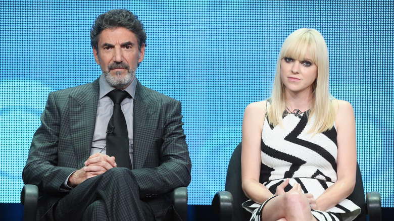 Chuck Lorre and Anna Faris seated on stage during a press tour in 2013