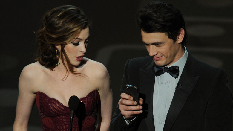 Anne Hathaway and James Franco with his phone
