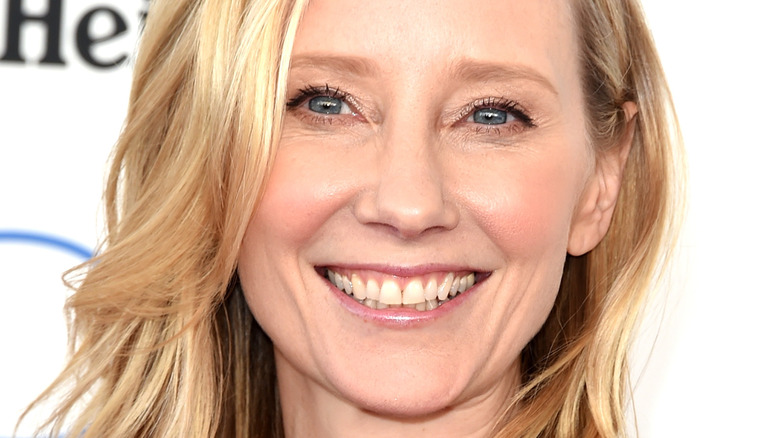 Anne Heche smiles against white backdrop
