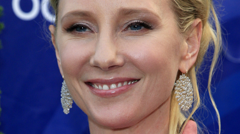 Anne Heche smiles in round pearl earrings