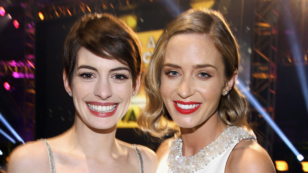 Anne Hathaway and Emily Blunt smiling