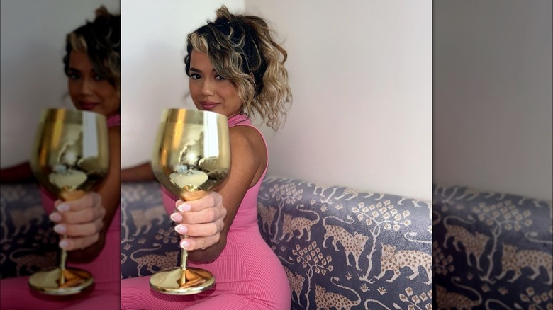 Nancy Rodriguez smiling with gold goblet