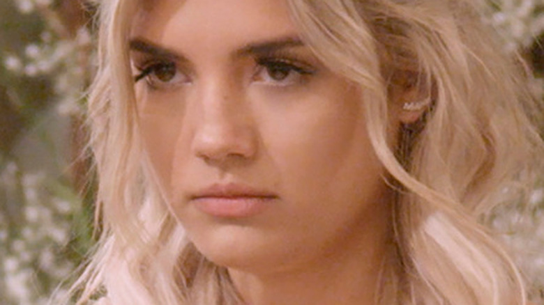 Giannina Gibelli frowning in wedding dress at the altar