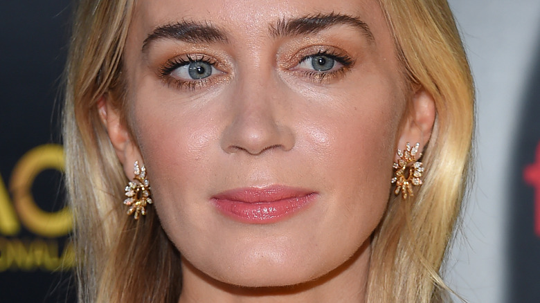 Emily Blunt poses in gold earrings