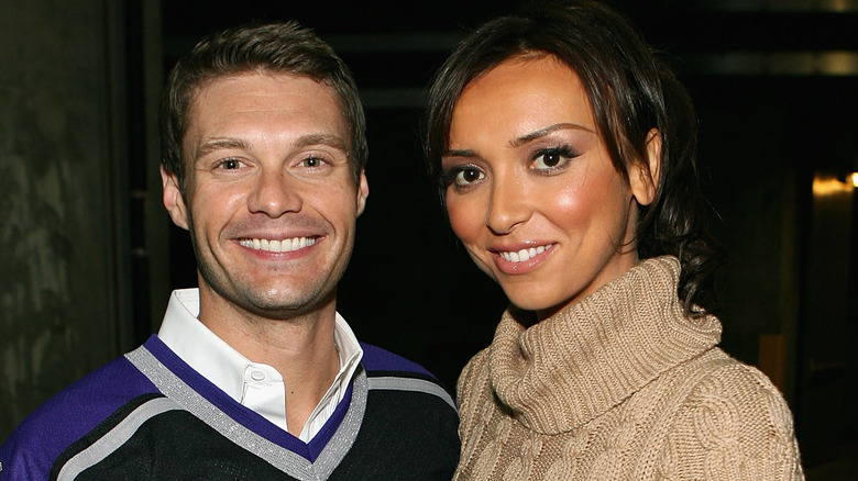 Ryan Seacrest posing with Giuliana Rancic