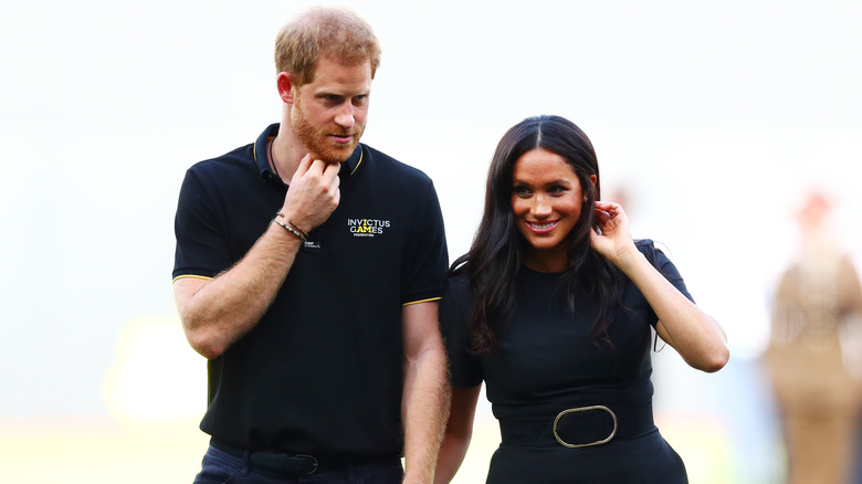 Prince Harry and Meghan Markle holding hands