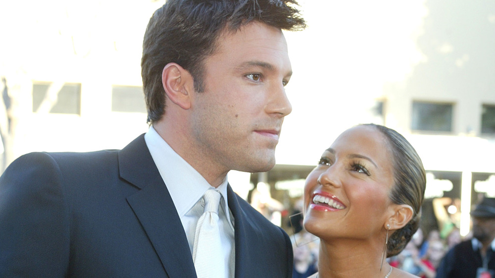 Ben Affleck and Jennifer Lopez pose on a red carpet together in 2003