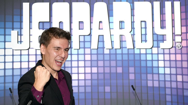 James Holzhauer posing in front of Jeopardy sign