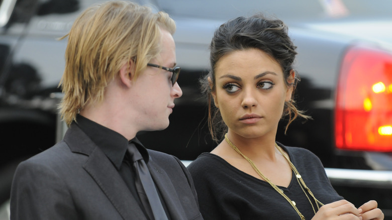 Macaulay Culkin and Mila Kunis looking at each other