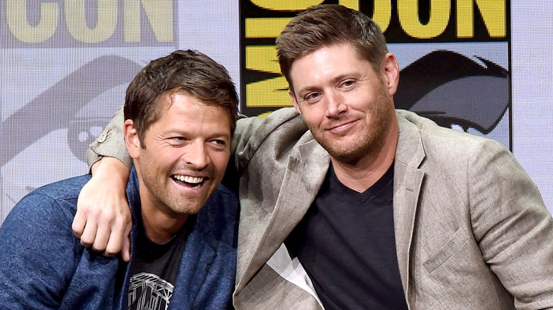 Jensen Ackles with arm wrapped around Misha Collins