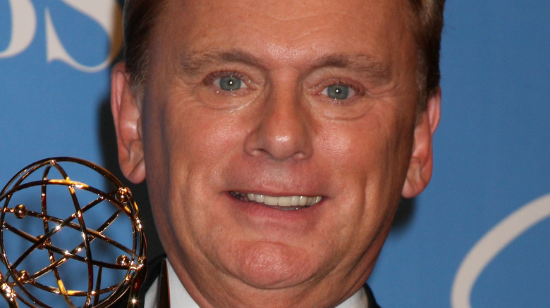 Pat Sajak holding Emmy up