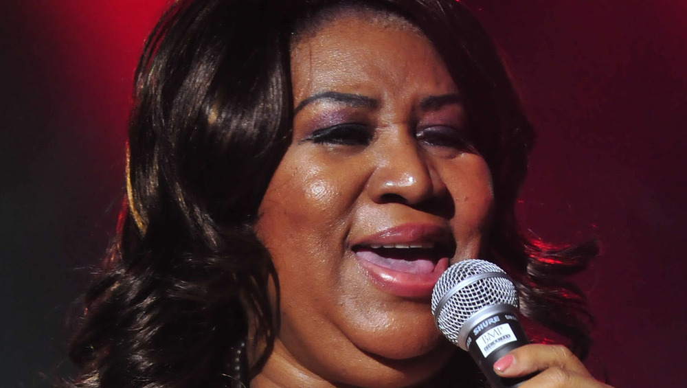 Aretha Franklin singing into a microphone