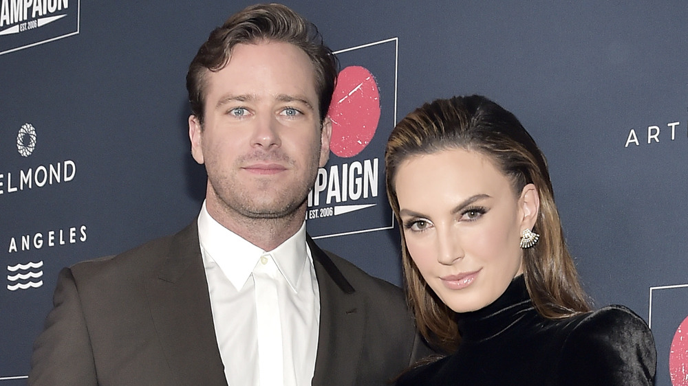 Armie Hammer and Elizabeth Chambers posing together at an event