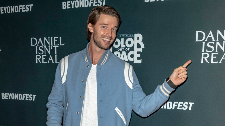 Patrick Schwarzenegger blue jacket pointing