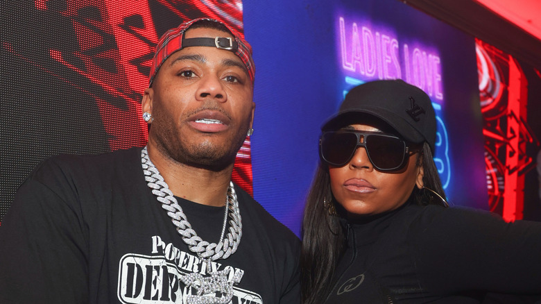 Nelly and Ashanti posing