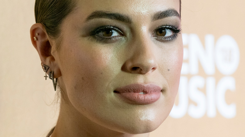 Ashley Graham poses with her hair pulled back