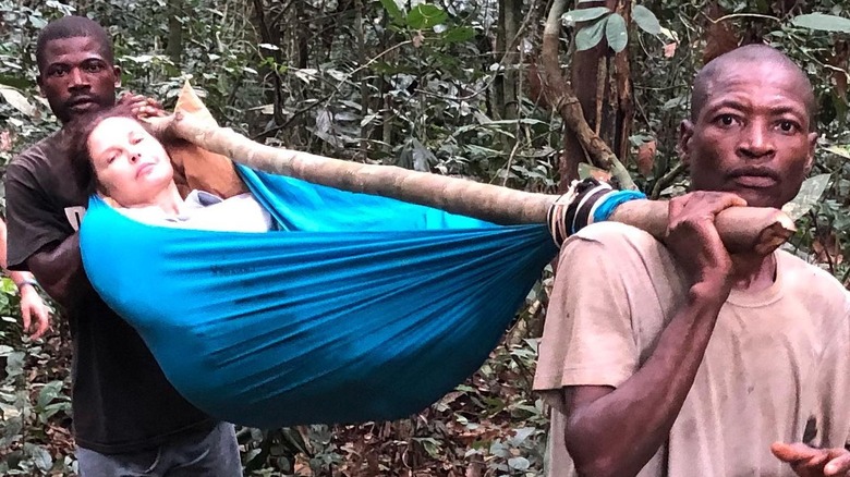 Ashley Judd being carried in hammock