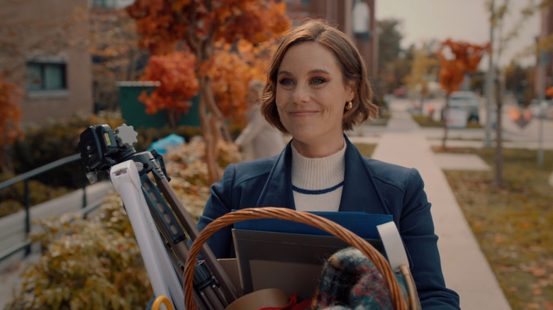 Ashley Williams holding multiple items in "Falling Together" in 2024