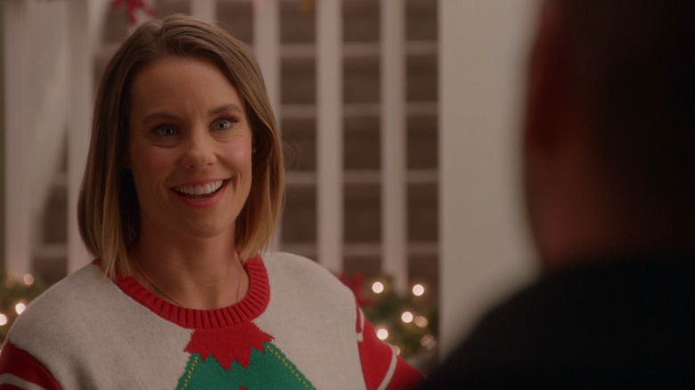 Ashley Williams smiling in "Never Kiss a Man in a Christmas Sweater"