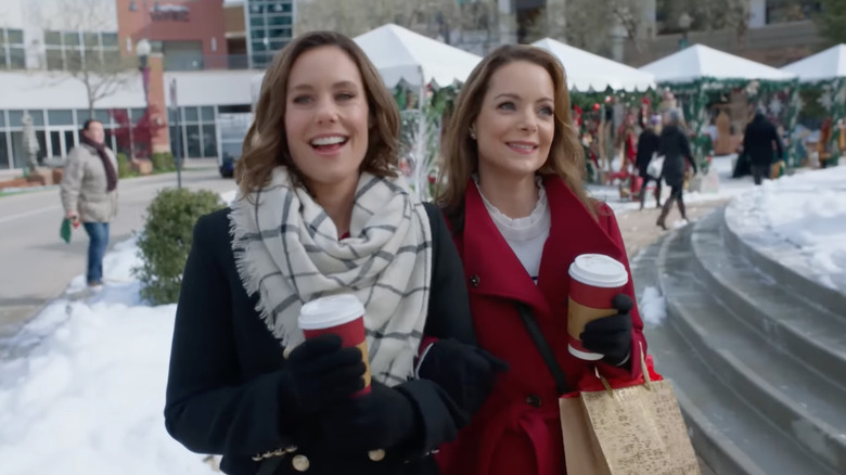 Ashley and Kimberly Williams holding coffee cups in "Sister Swap" on Hallmark